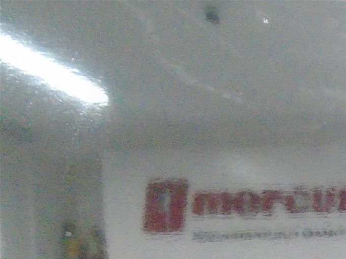 Behind plastic. Pharmacists at Mercury Drug.